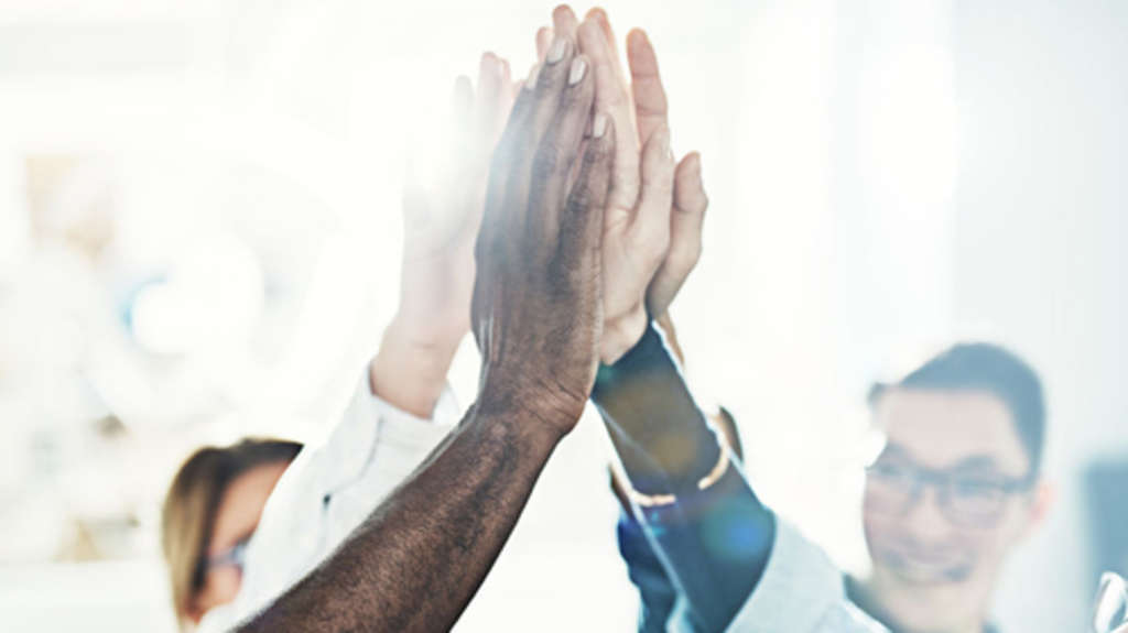 Group of diverse businesspeople high fiving together in an offic, Link auf Fair geht vor! - Köln für den fairen Handel