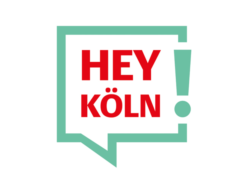 Eckige Sprechblase in grün mit Text in roter Schrift: Hey Köln!