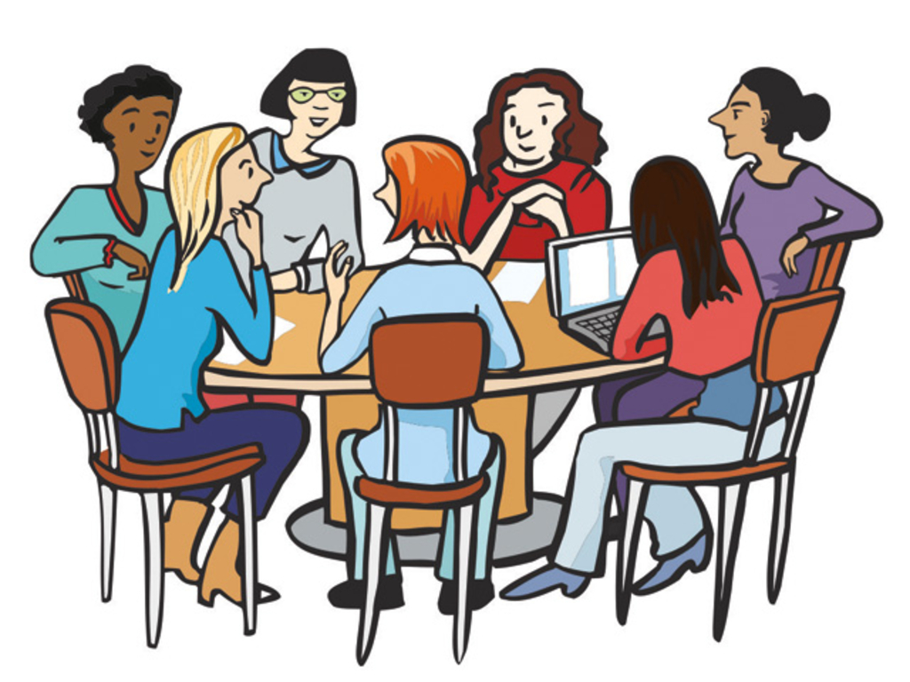 Sieben Frauen sitzen an einem runden Tisch und sprechen miteinander.