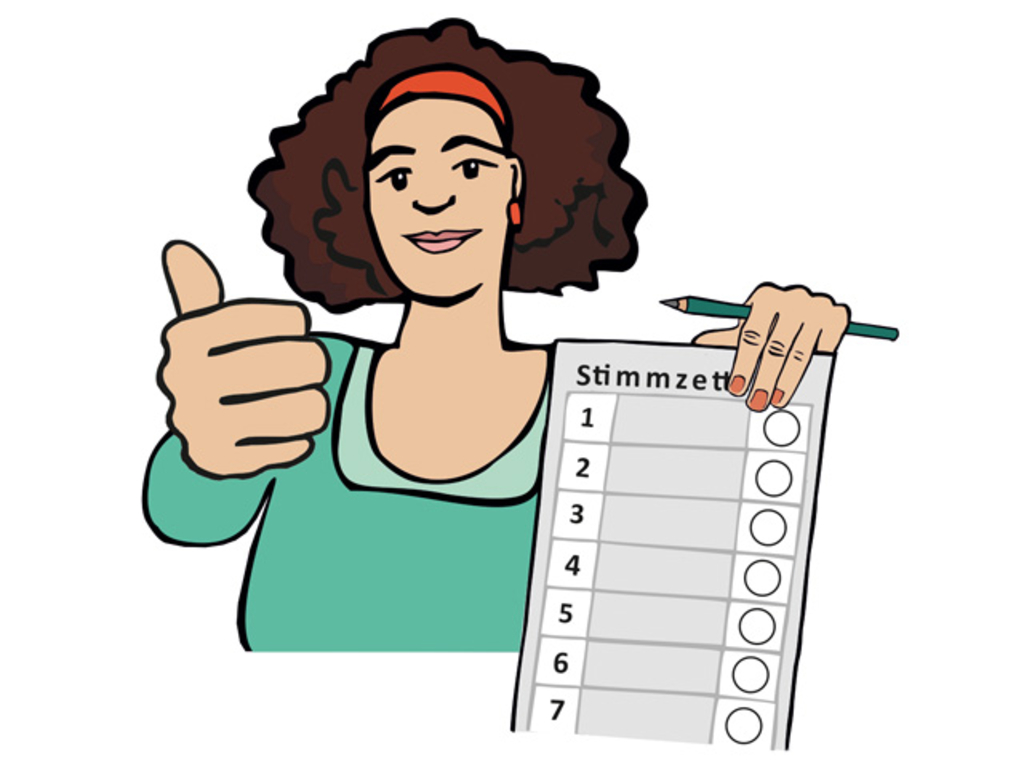 Eine Frau zeigt einen Stimmzettel. Mit einer Hand macht sie eine Faust und hält ihren Daumen hoch.
