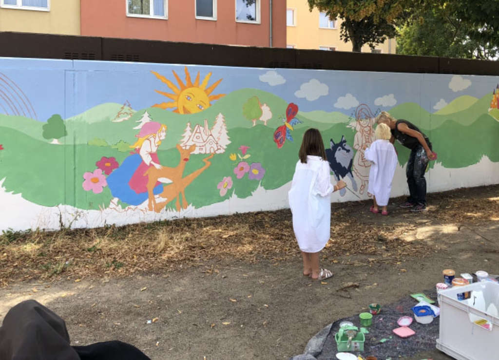 Kinder bemalen Garagenrückwand