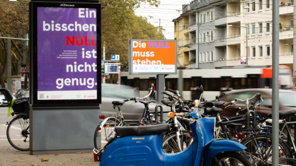 Bild eines Plakates der Klimakampagne in der Stadt, Link auf Klimaschutz Köln: Köln wird klimaneutral bis 2035