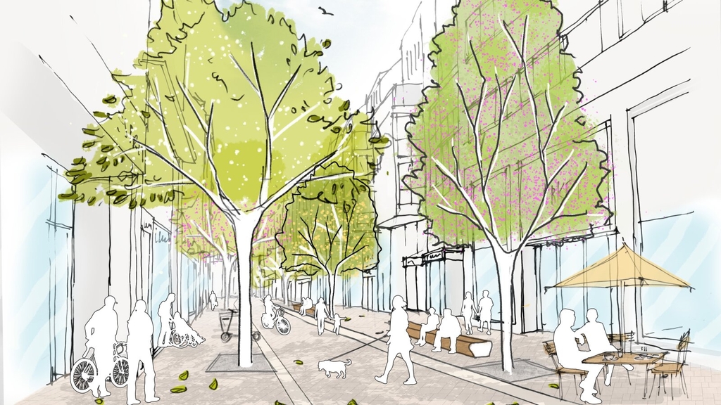 Visualisierung der geplanten Umgestaltung der Ehrenstraße. Zu sehen ist ein Boulevard, auf dem zu Fuß Gehende und Radfahrende unterwegs sind. An der Seite sind viele Bäume zu sehen. Zudem sieht man Sitzgelegenheiten und Gastronomie.