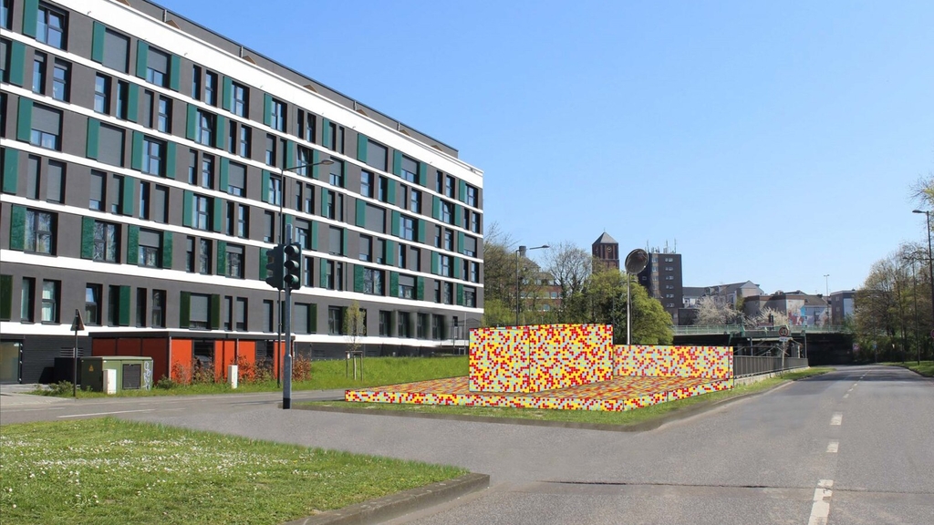 Darstellung der geplanten Rampe am Perlengraben. Die Rampe liegt neben der Straße auf einem breiten Grünstreifen. Das bunte Design der Rampe soll Blumen darstellen.