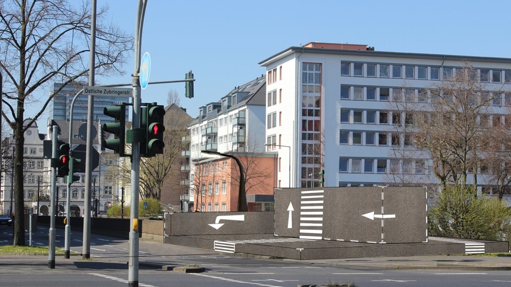 Darstellung der geplanten Rampe an der Deutz-Kalker-Straße. Die Rampe liegt an der Straßenkreuzung neben dem Fußweg. Das Design der Rampe stellt Straßenmarkierungen dar.