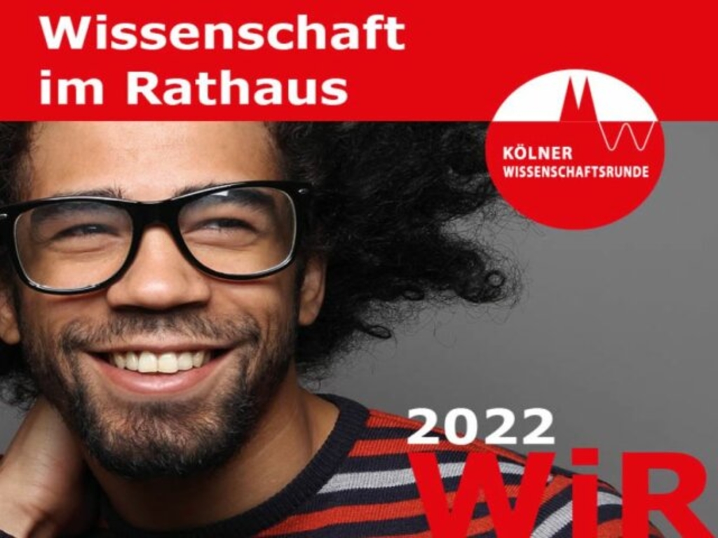 Mann neben Logo von Wissenschaft im Rathaus