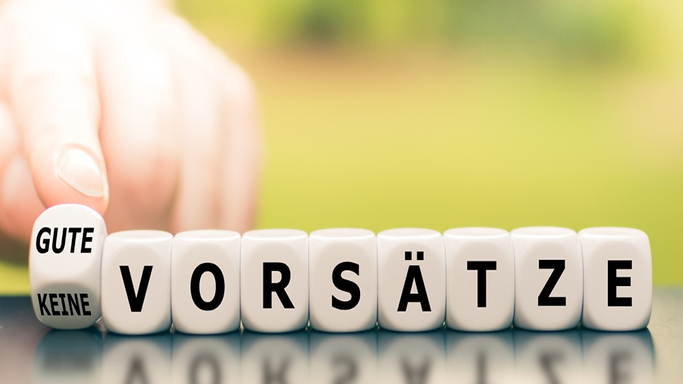 neun Würfel nebeneinander aufgestellt, auf denen dann das Wort Gute Vorsätze zu lesen ist.